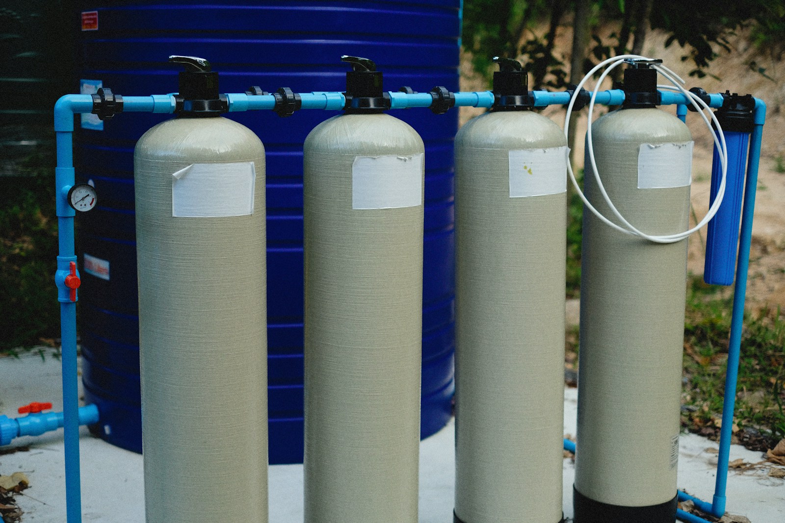 Water treatment tanks with control valves, a pressure gauge and a filter housing